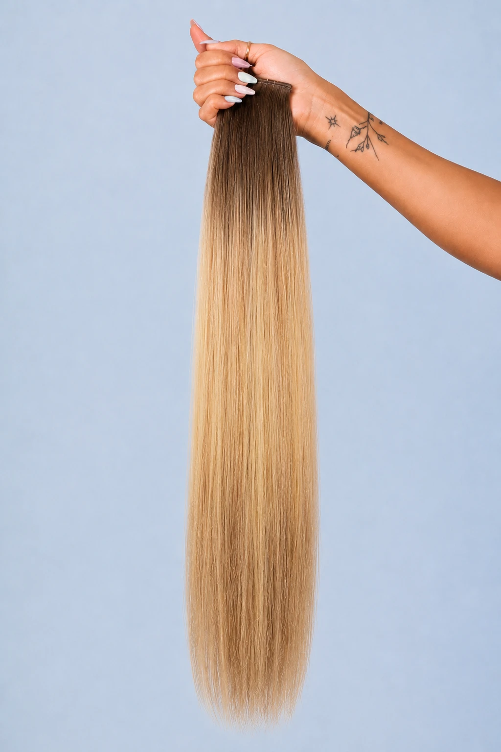 10 rooted blonde — hand held, pale blue seamless